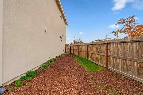 a view of a pathway with a wrought fence