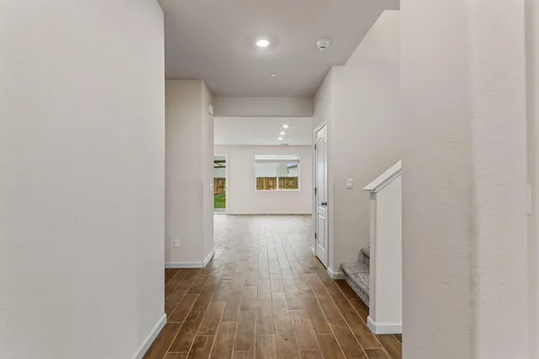 a view of a hallway with wooden floor