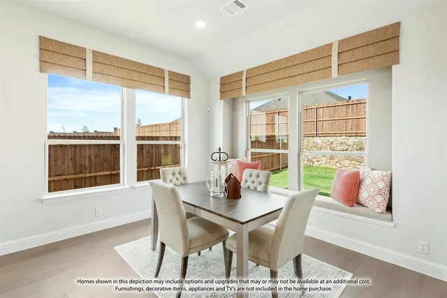 a dining room with furniture and windows