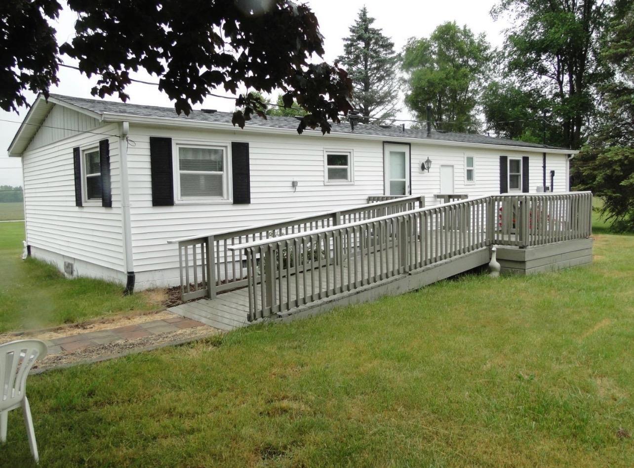 612 West 100 South Hebron, IN 46341 - Photo 13 of 18 a view of a house with a yard and a wooden deck