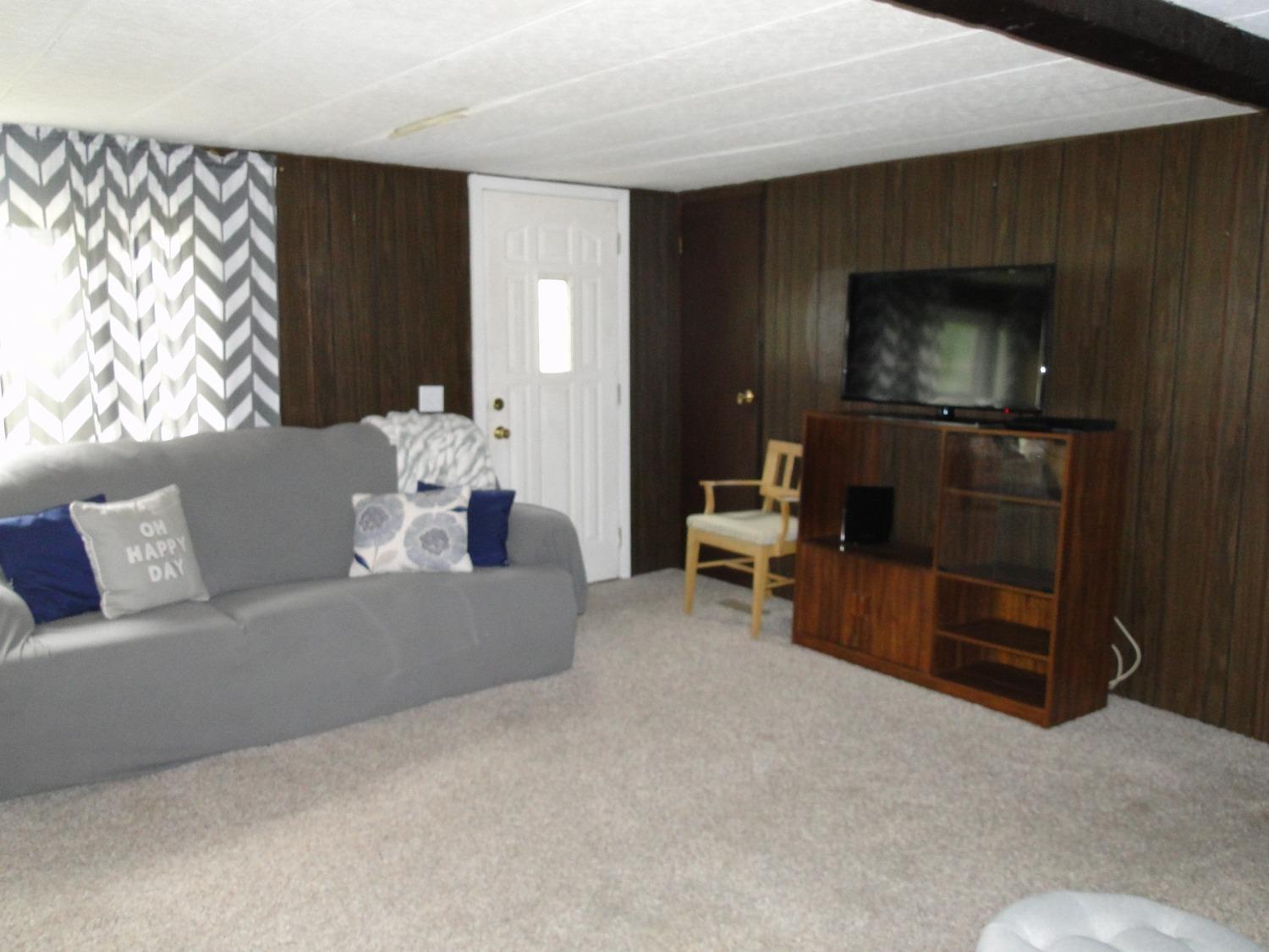 612 West 100 South Hebron, IN 46341 - Photo 2 of 18 a living room with furniture and a flat screen tv