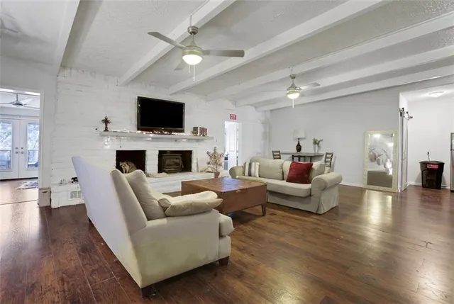 a living room with furniture a flat screen tv and a fireplace