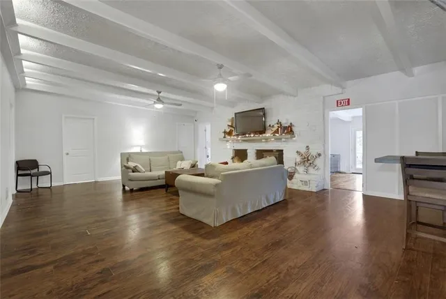 a living room with furniture and a kitchen view