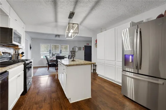 a kitchen with counter top space and stainless steel appliances