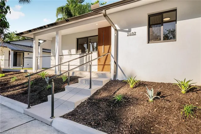 a living room with furniture and a ceiling fan