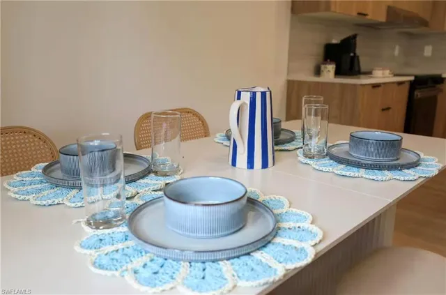 a living room with furniture and large windows