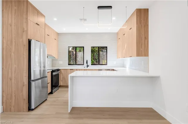 a bathroom with a double vanity sink a mirror and a bathtub
