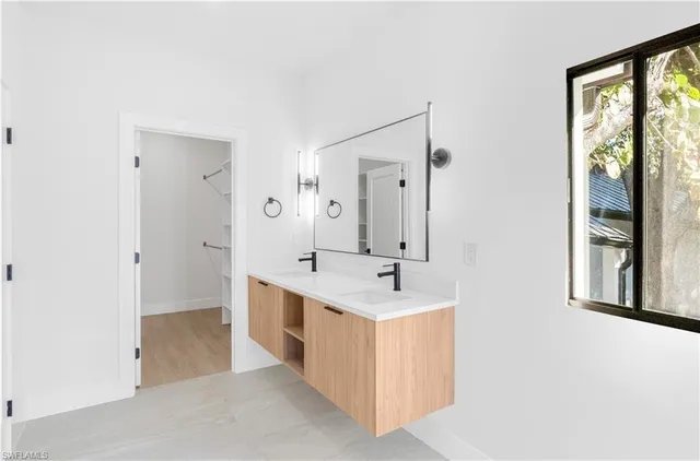 a view of a kitchen with wooden floor and a refrigerator