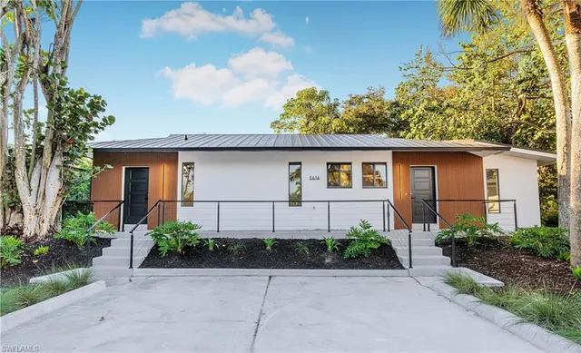 a front view of a house with garden