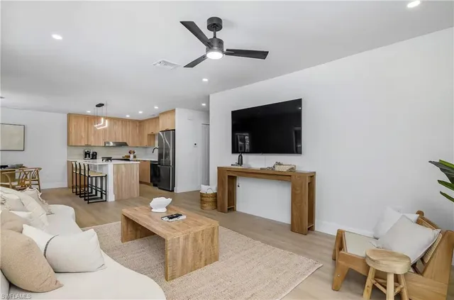 a kitchen with a dining table chairs and white cabinets