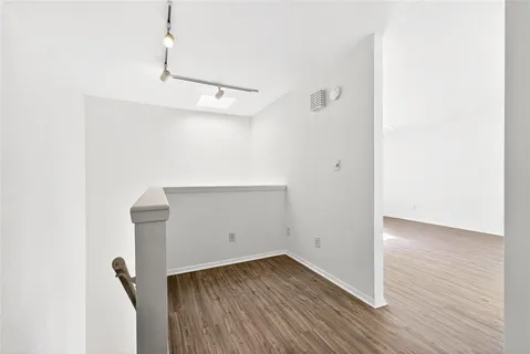 a view of a room with wooden floor and fan