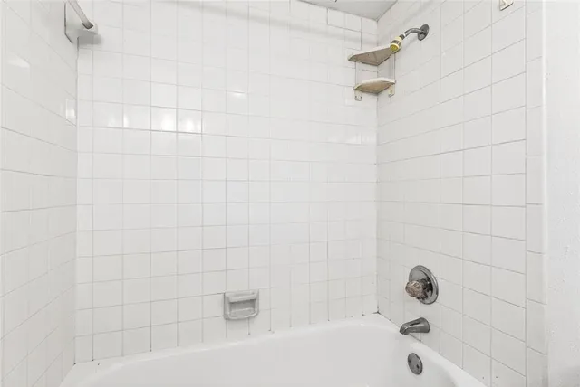 a bathroom with a bathtub and shower
