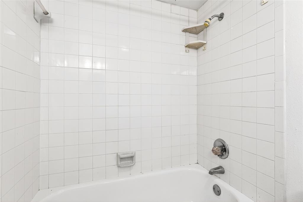 4338 Hartford Street, Unit 7 Dallas, TX 75219 - Photo 15 of 23 a bathroom with a bathtub and shower