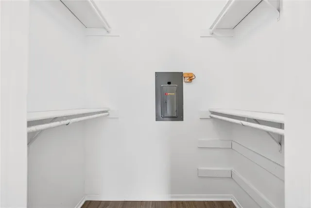 a view of walk in closet with empty racks