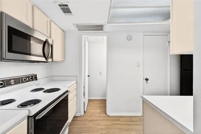 a kitchen with stainless steel appliances white cabinets and a stove