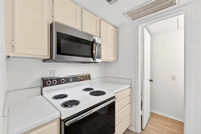 a kitchen with a stove and a microwave