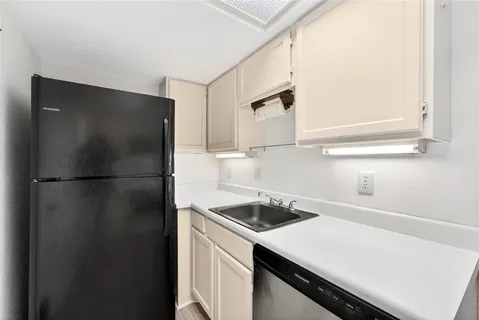a kitchen with a refrigerator and a stove