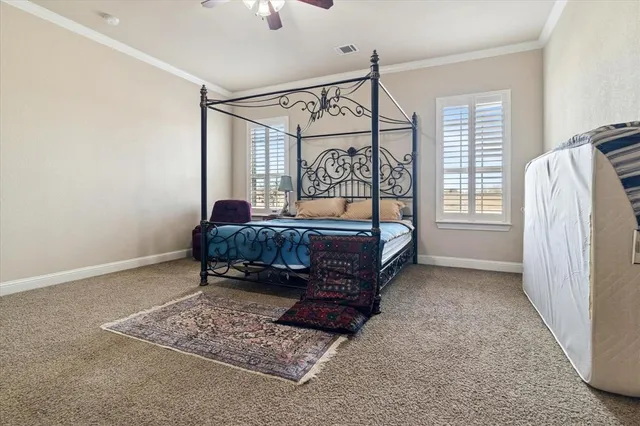 a bed sitting in a bedroom next to a window