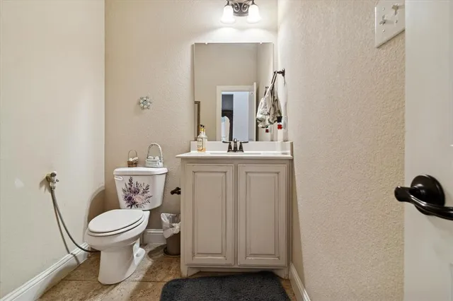 a bathroom with a toilet a sink and mirror
