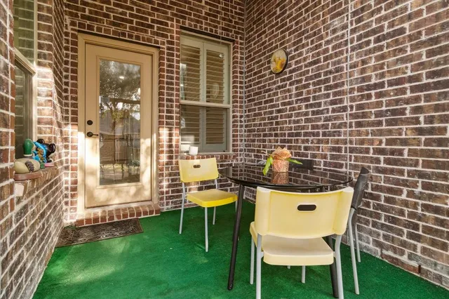 a balcony with table and chairs