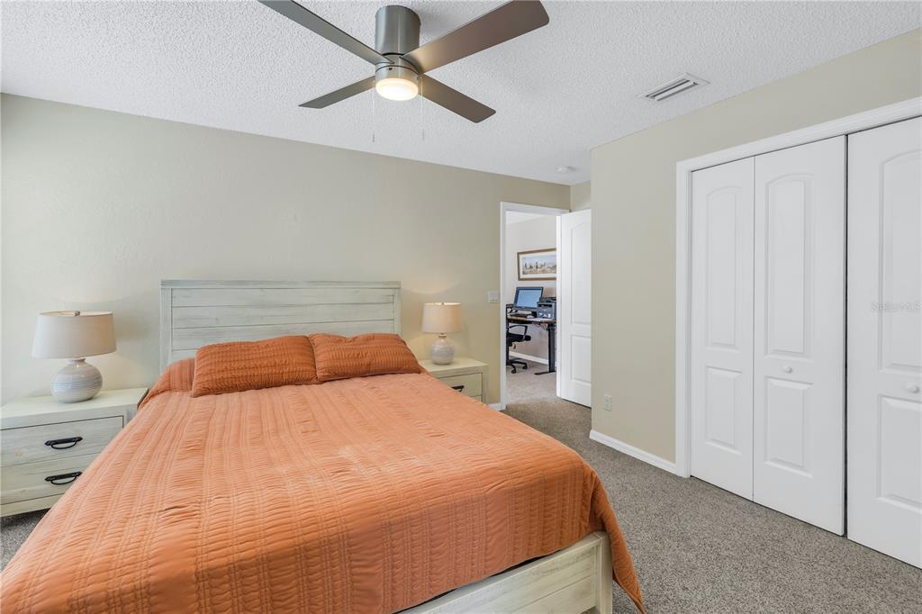 1050 Starkey Road, Unit 2201 Largo, FL 33771 - Photo 16 of 68 a bedroom with a large bed and a chandelier