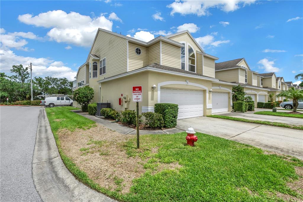 1050 Starkey Road, Unit 2201 Largo, FL 33771 - Photo 3 of 68 a front view of a house with a yard and garage