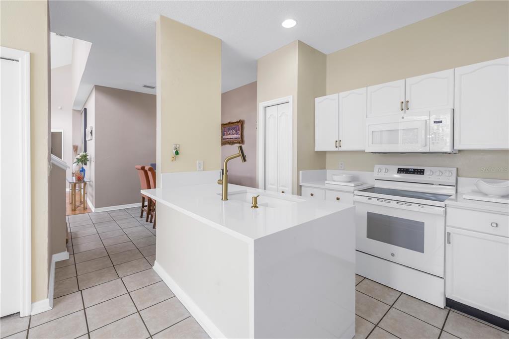 1050 Starkey Road, Unit 2201 Largo, FL 33771 - Photo 35 of 68 a kitchen with a sink cabinets and appliances