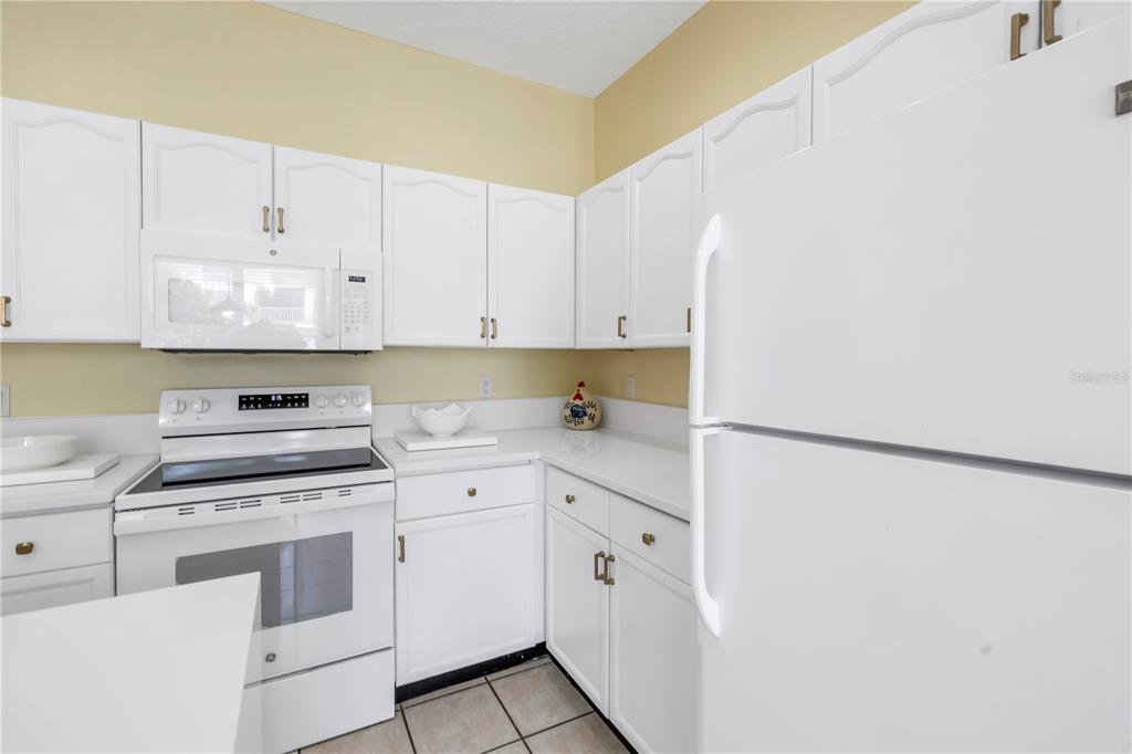 1050 Starkey Road, Unit 2201 Largo, FL 33771 - Photo 36 of 68 a kitchen with cabinets appliances and a sink