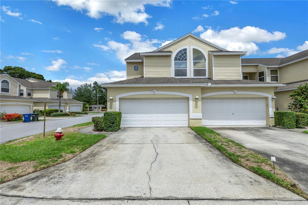 1050 Starkey Road, Unit 2201 Largo, FL 33771 - Photo 4 of 68 a front view of a house with a yard and garage