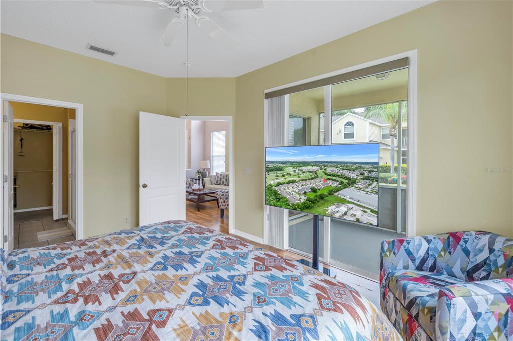 1050 Starkey Road, Unit 2201 Largo, FL 33771 - Photo 53 of 68 a bedroom with a bed and a chandelier