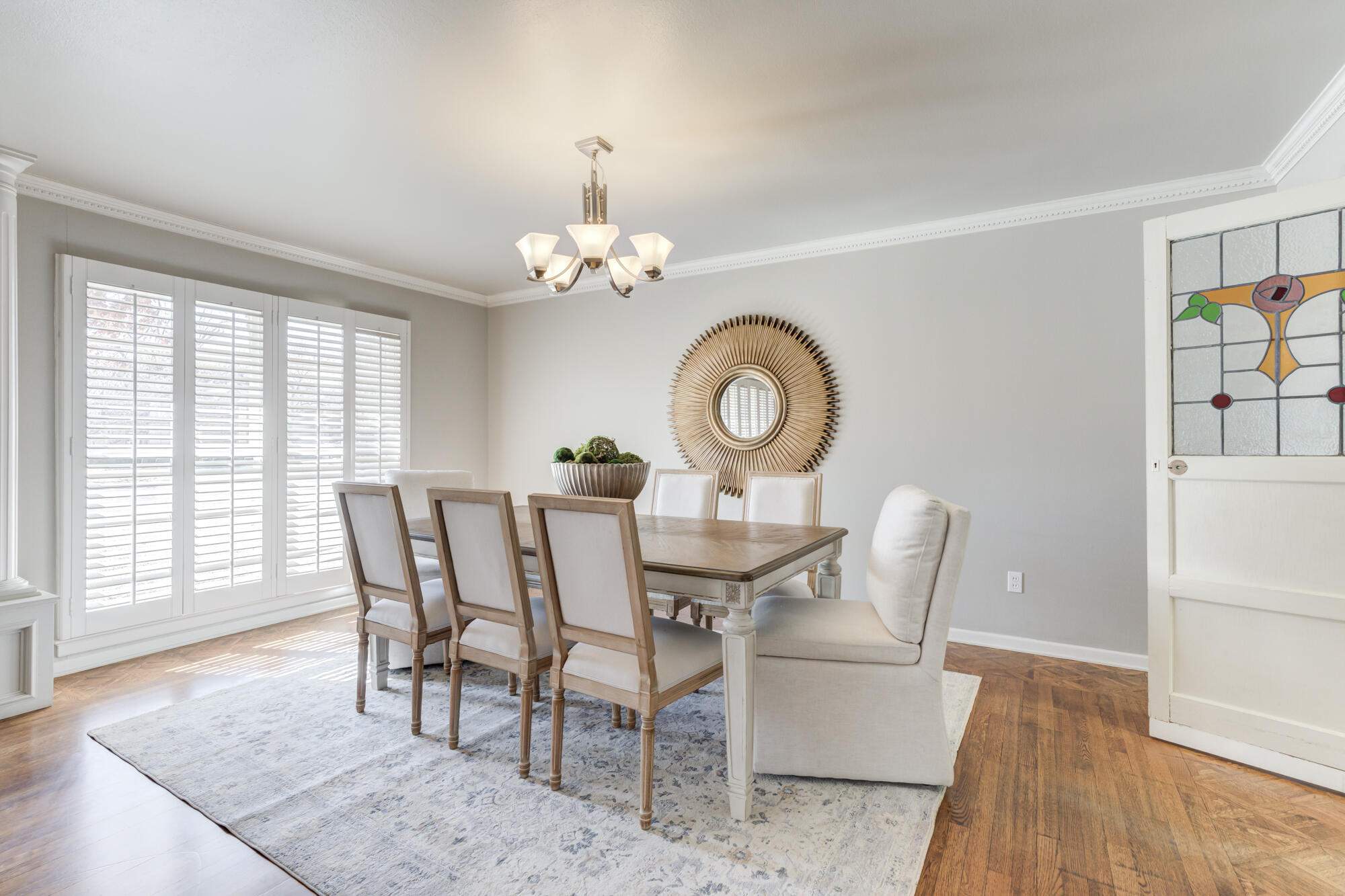 4608 18th Street Lubbock, TX 79416 - Photo 13 of 84 a view of a dining room with furniture a chandelier and wooden floor