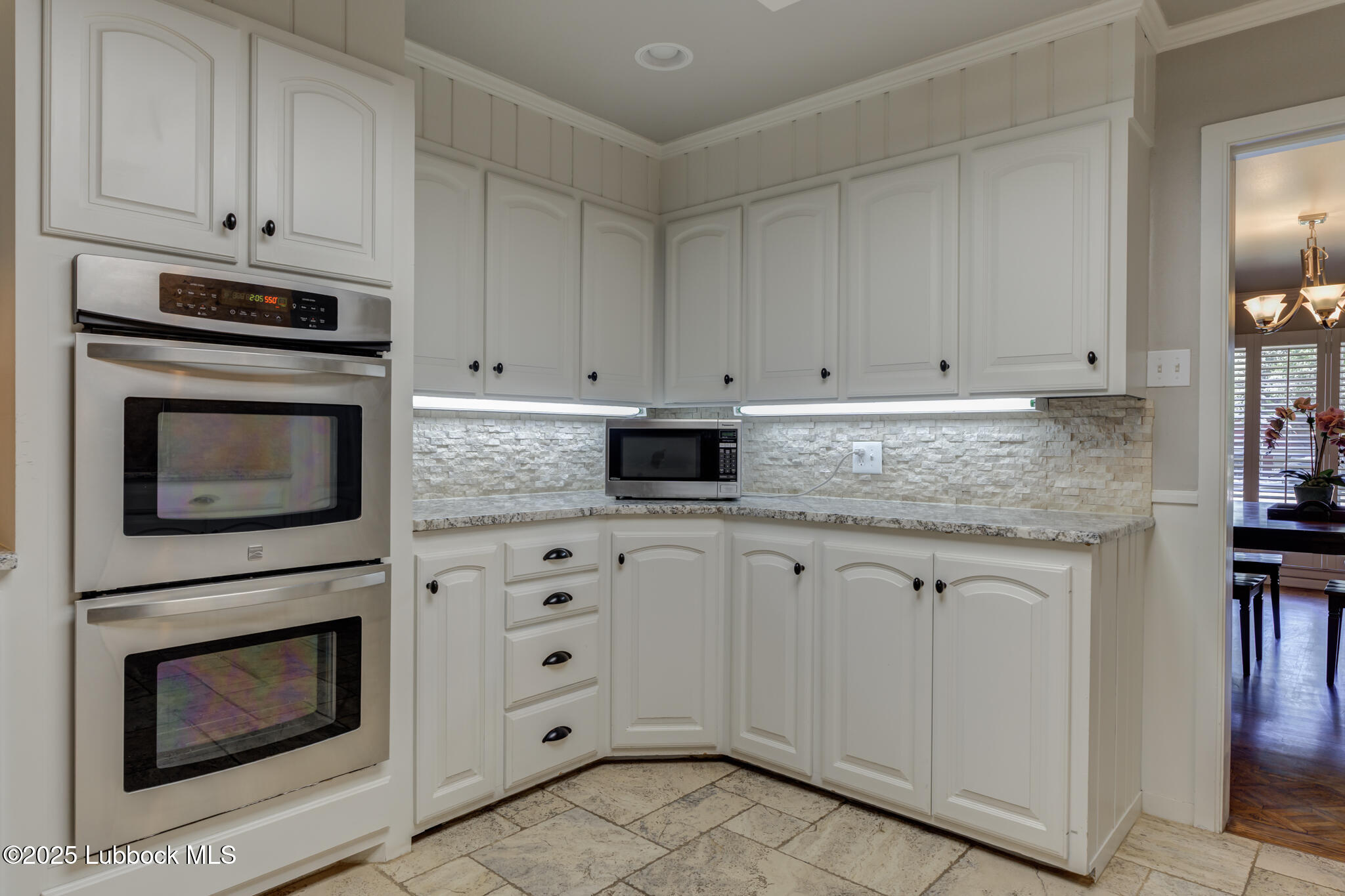 4608 18th Street Lubbock, TX 79416 - Photo 26 of 84 a kitchen with granite countertop white cabinets stainless steel appliances and sink