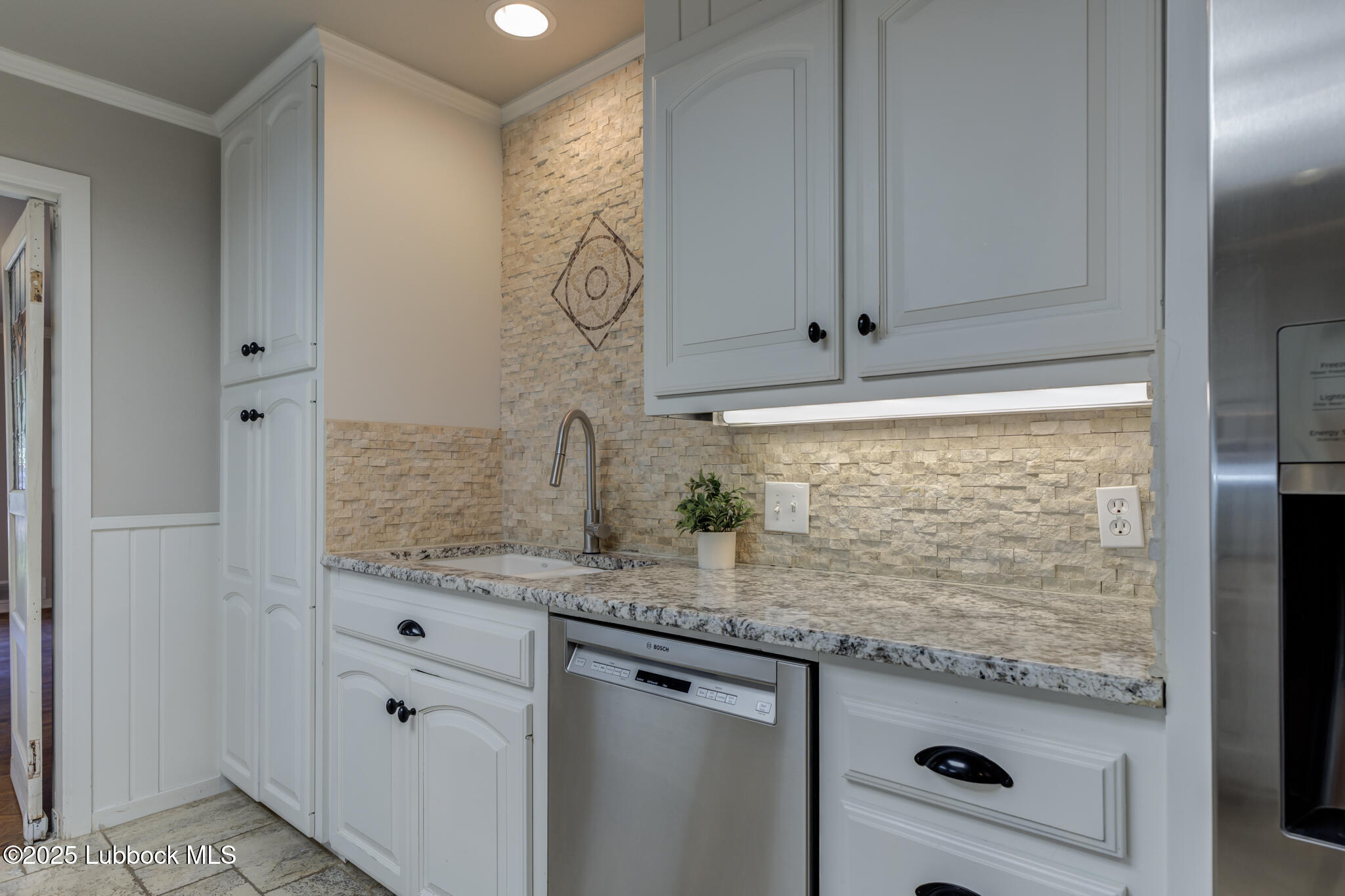 4608 18th Street Lubbock, TX 79416 - Photo 28 of 84 a bathroom with a granite countertop sink and a mirror