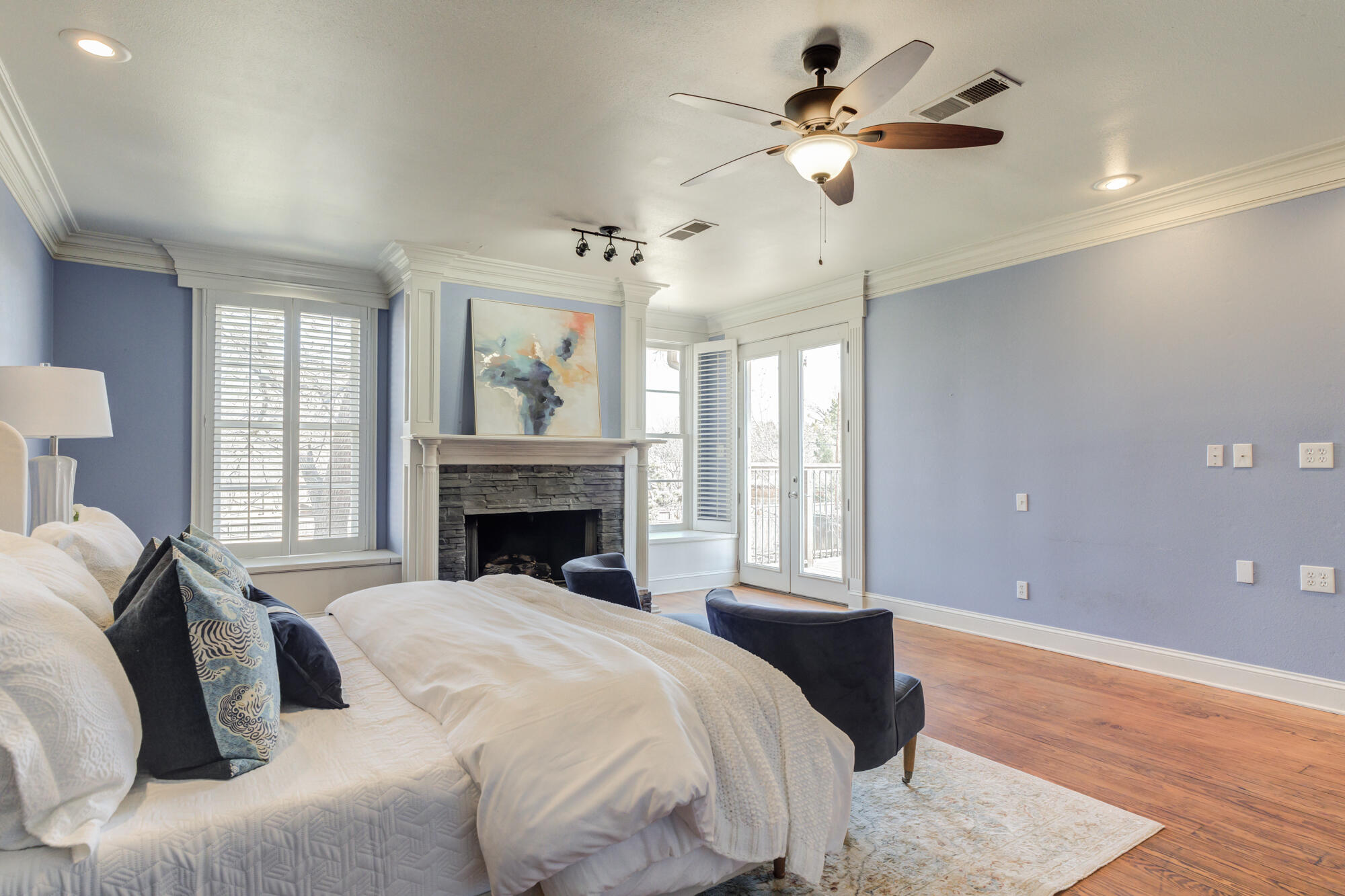 4608 18th Street Lubbock, TX 79416 - Photo 48 of 84 a spacious bedroom with a large bed and a chandelier