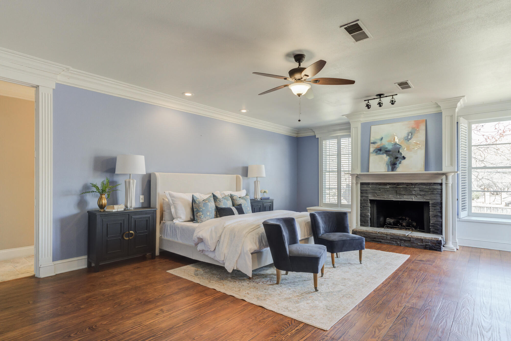 4608 18th Street Lubbock, TX 79416 - Photo 50 of 84 a bedroom with a bed and a fireplace
