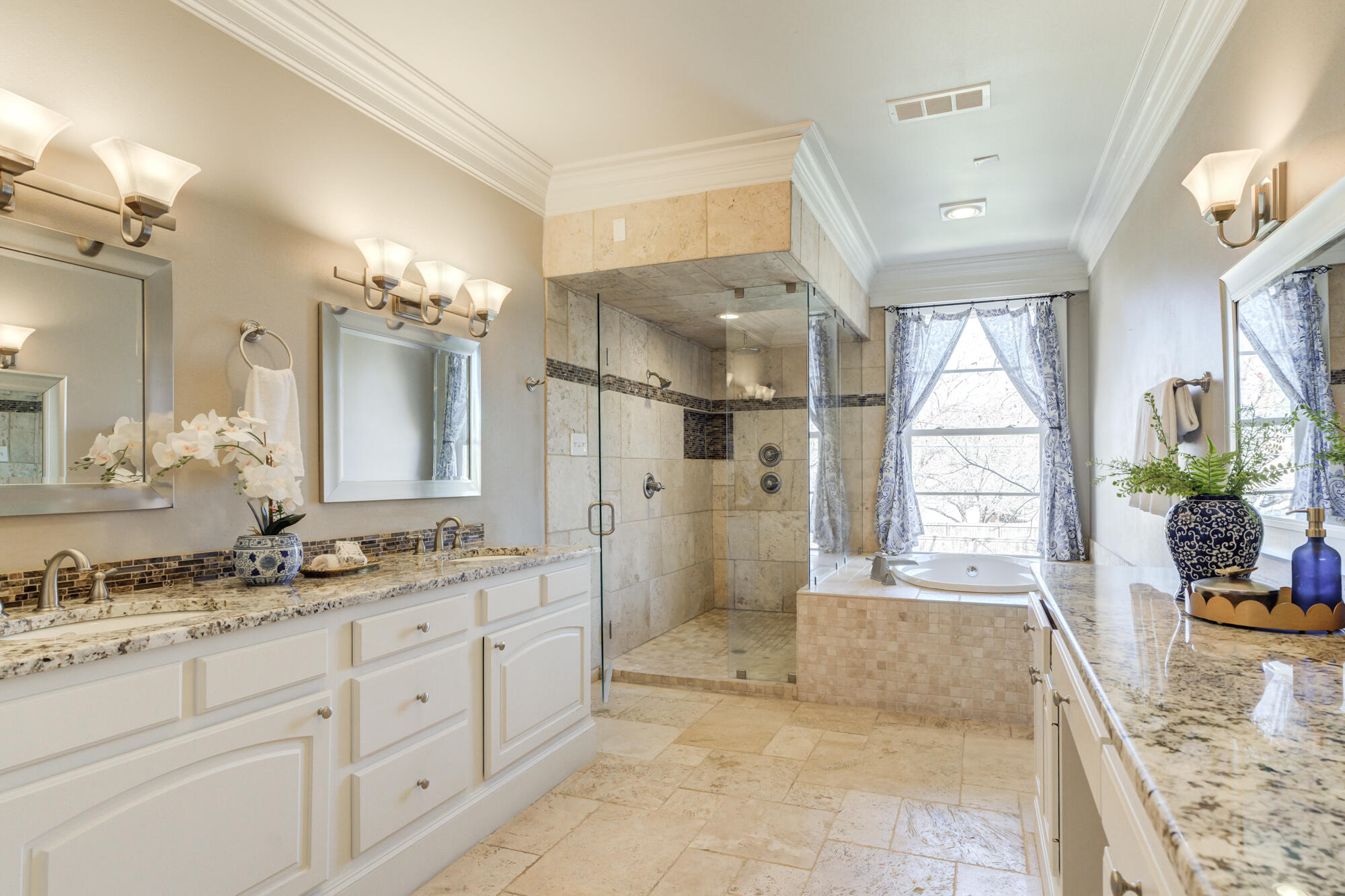 4608 18th Street Lubbock, TX 79416 - Photo 54 of 84 a spacious bathroom with a granite countertop sink mirror and shower