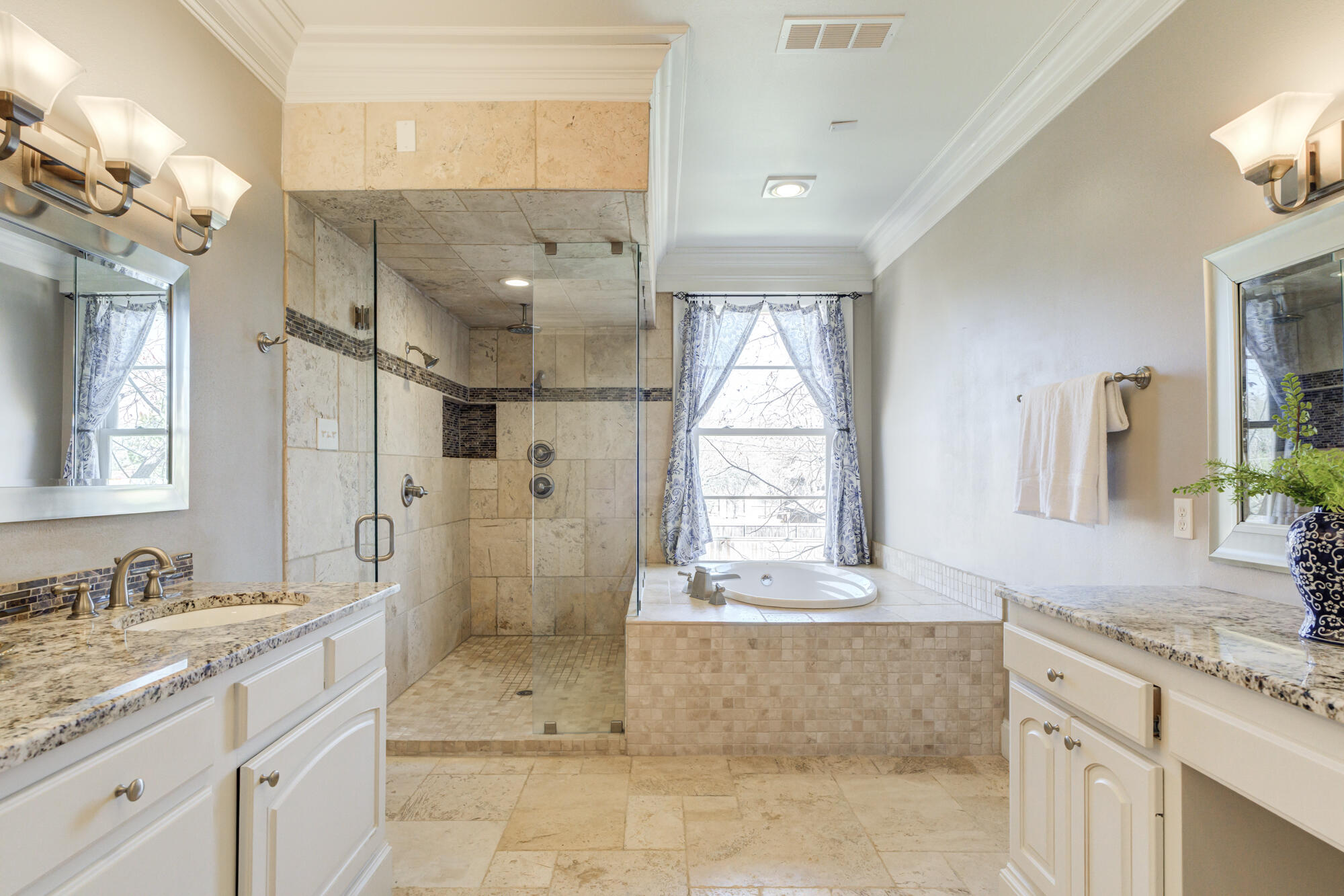 4608 18th Street Lubbock, TX 79416 - Photo 55 of 84 a bathroom with a granite countertop sink a toilet a mirror and shower