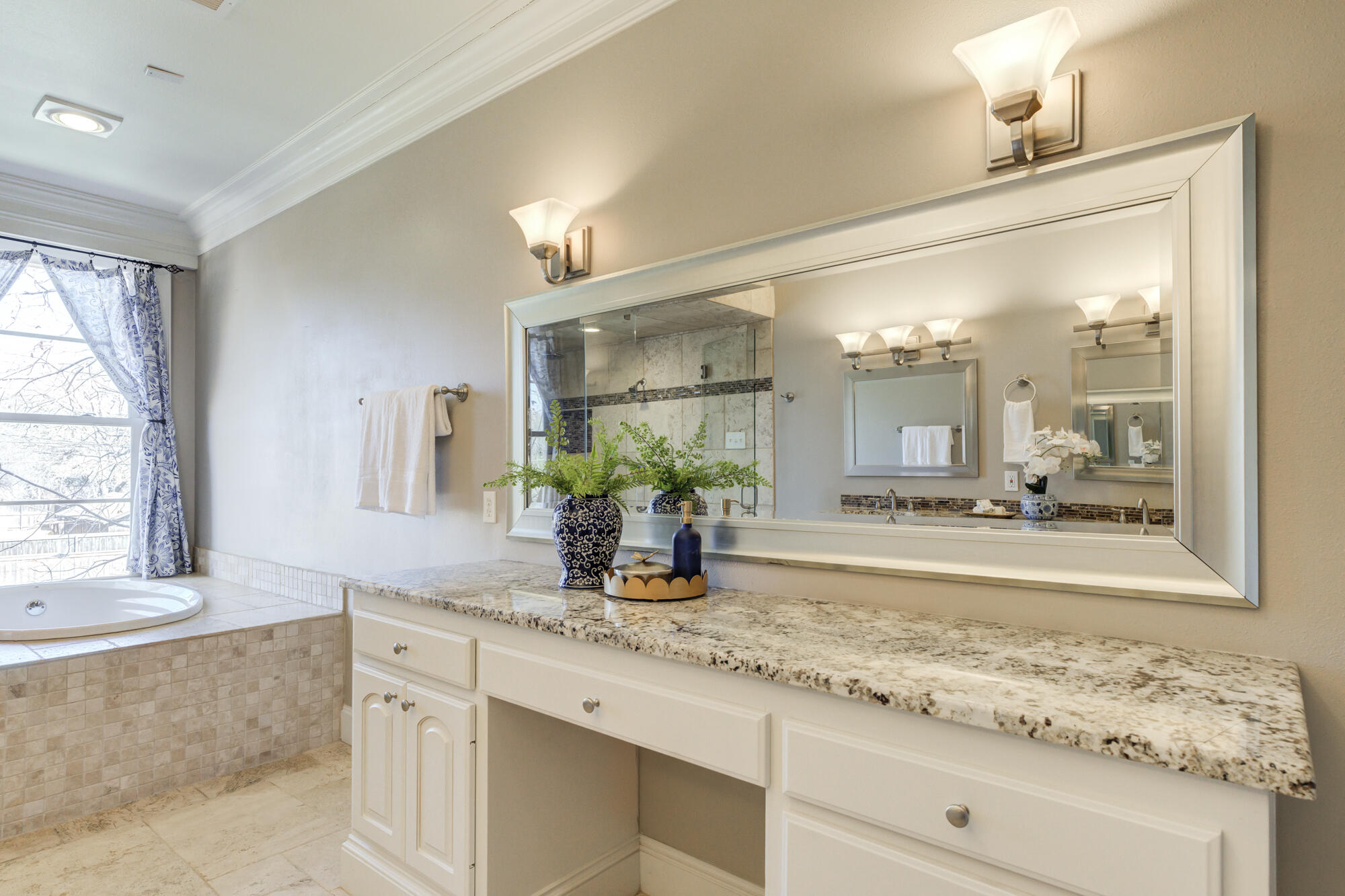 4608 18th Street Lubbock, TX 79416 - Photo 56 of 84 a bathroom with a granite countertop sink and a mirror