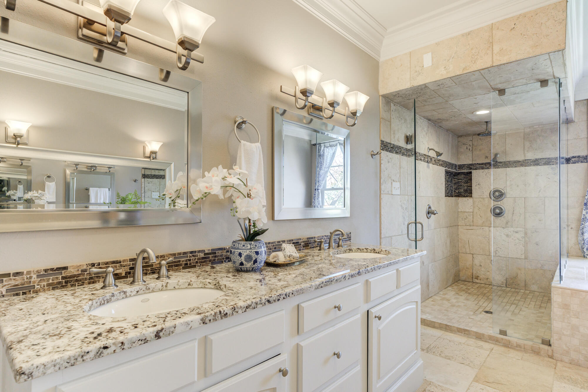 4608 18th Street Lubbock, TX 79416 - Photo 57 of 84 a bathroom with a granite countertop sink mirror and shower