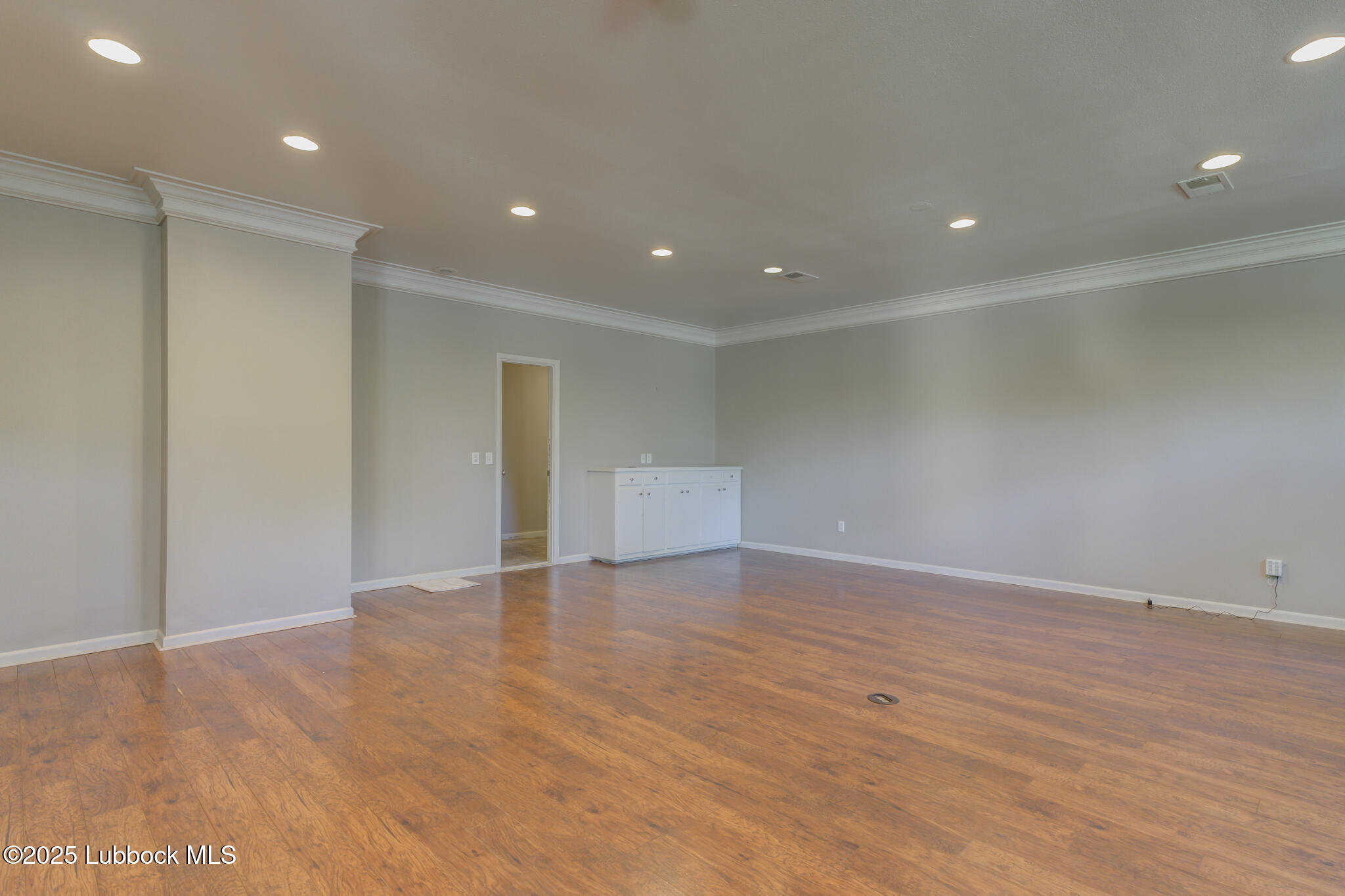 4608 18th Street Lubbock, TX 79416 - Photo 75 of 84 a view of an empty room with wooden floor