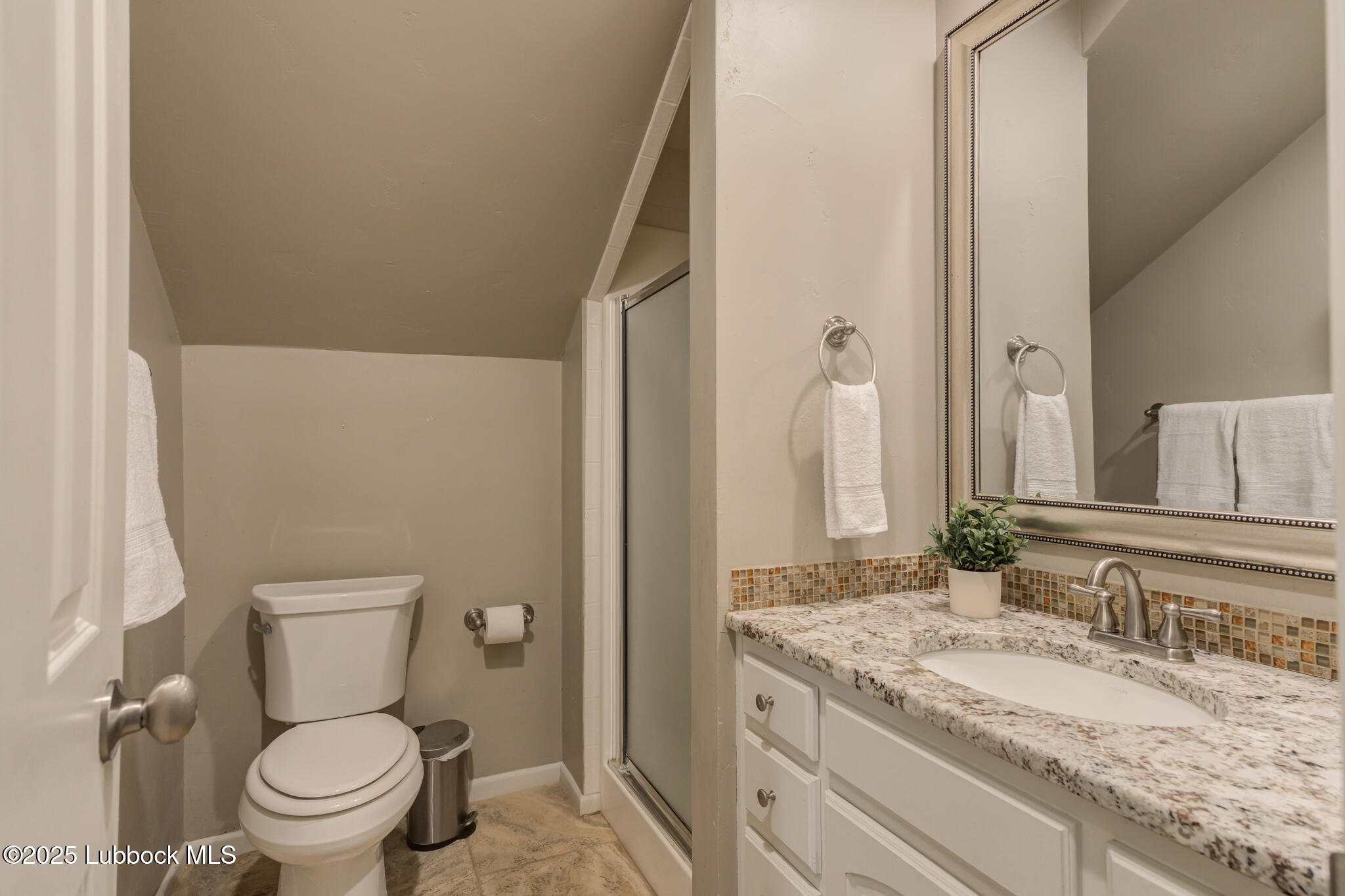 4608 18th Street Lubbock, TX 79416 - Photo 76 of 84 a bathroom with a granite countertop toilet and a sink