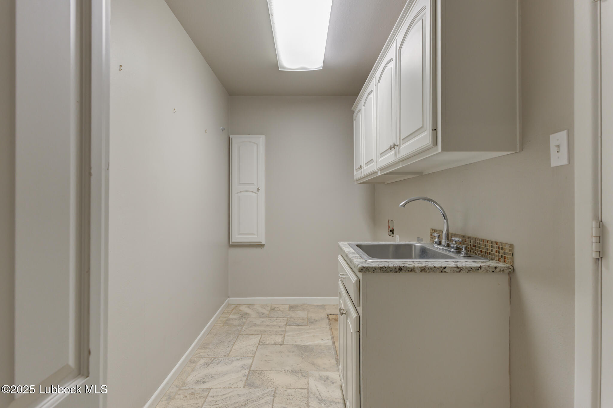 4608 18th Street Lubbock, TX 79416 - Photo 78 of 84 a kitchen with a sink and cabinets