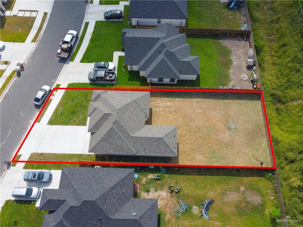 1920 Trinity Street Donna, TX 78537 - Photo 19 of 23 Aerial perspective highlighting a residential property with a shingled roof and an expansive rear yard