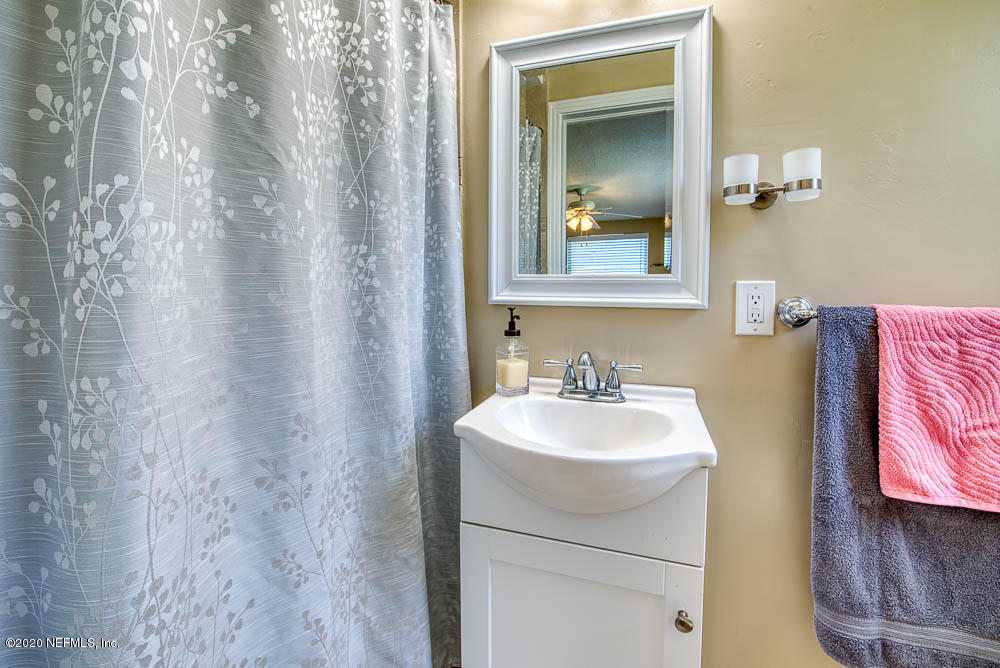 5128 Spring Glen Road Jacksonville, FL 32207 - Photo 15 of 24 a bathroom with a sink vanity and mirror