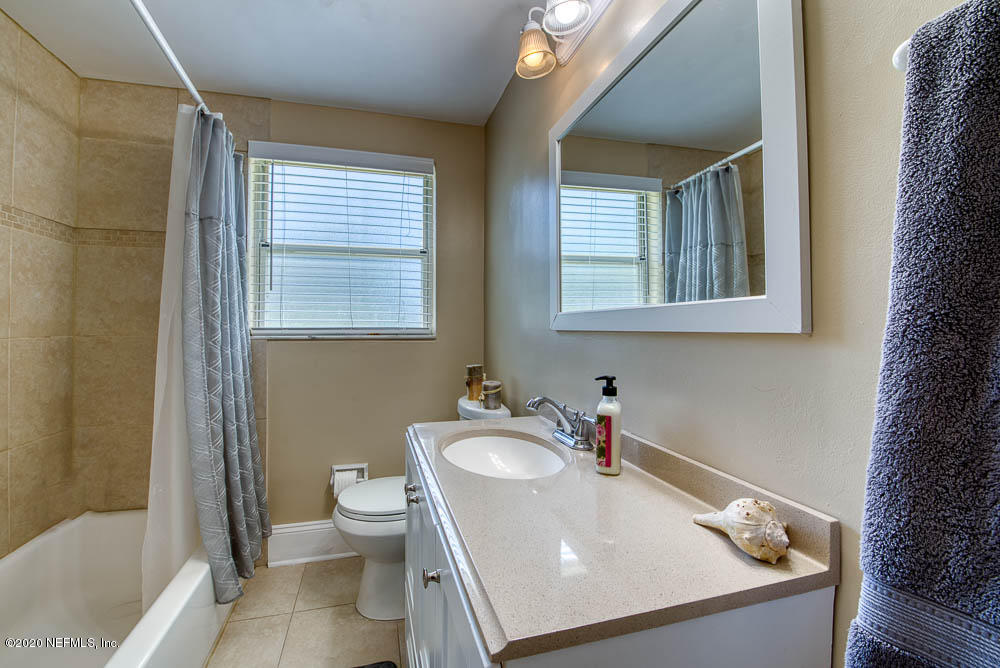 5128 Spring Glen Road Jacksonville, FL 32207 - Photo 19 of 24 a bathroom with a sink toilet and shower