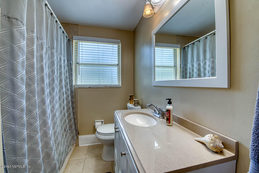 5128 Spring Glen Road Jacksonville, FL 32207 - Photo 20 of 24 a bathroom with a sink toilet and shower