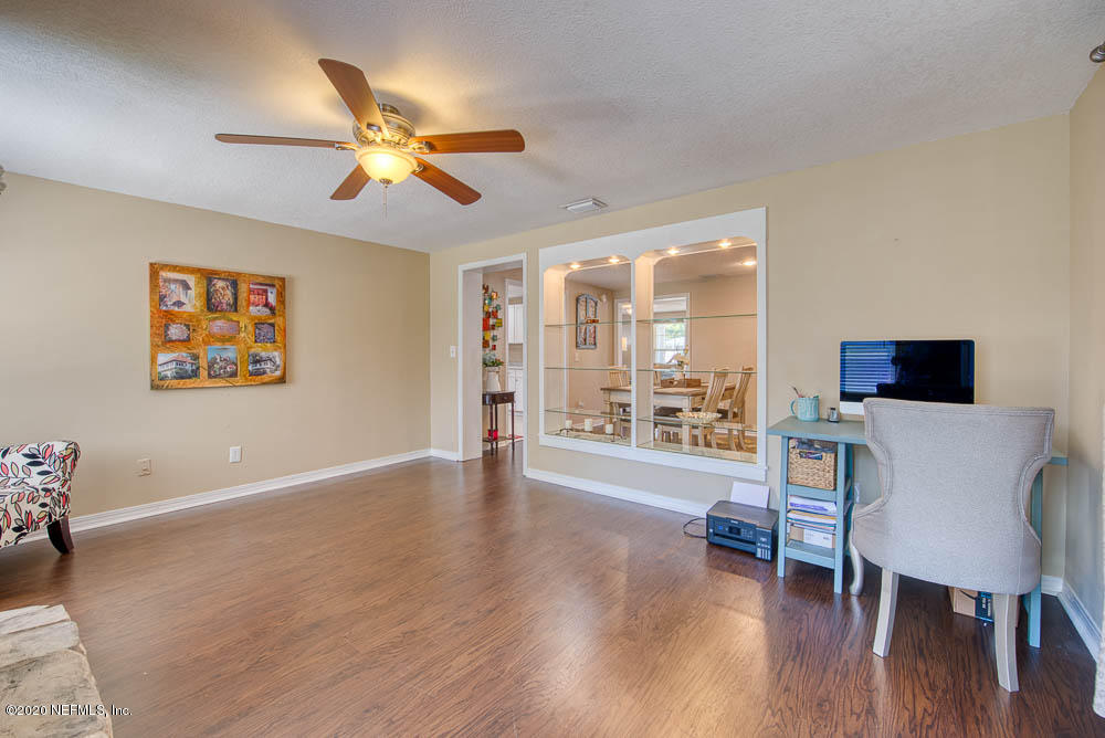 5128 Spring Glen Road Jacksonville, FL 32207 - Photo 5 of 24 a view of a livingroom with furniture wooden floor and a ceiling fan