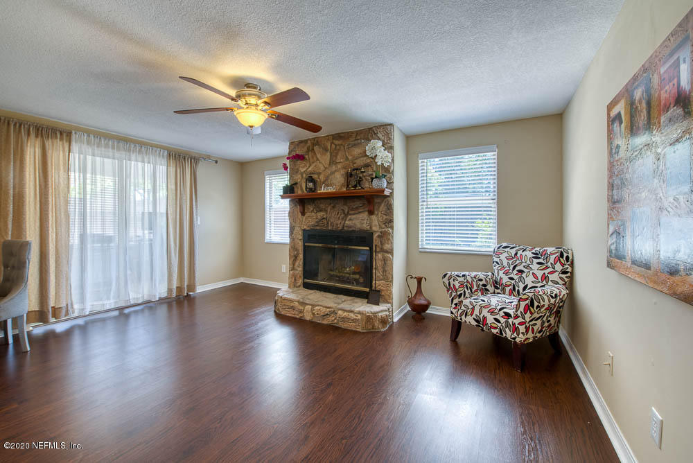 5128 Spring Glen Road Jacksonville, FL 32207 - Photo 6 of 24 a view of a livingroom with hardwood floor and a ceiling fan
