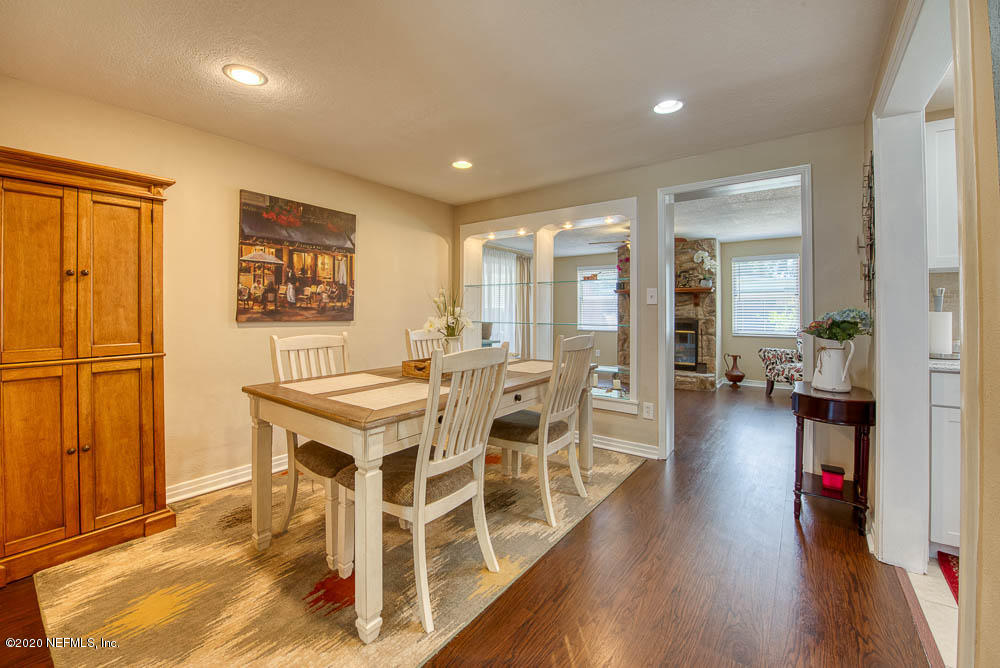 5128 Spring Glen Road Jacksonville, FL 32207 - Photo 9 of 24 a living room with stainless steel appliances granite countertop a table chairs and a refrigerator
