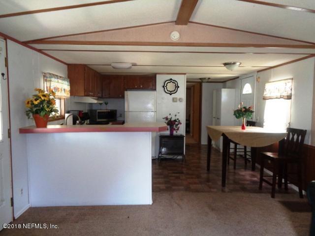 218 Violet Avenue Interlachen, FL 32148 - Photo 6 of 12 living room to kitchen